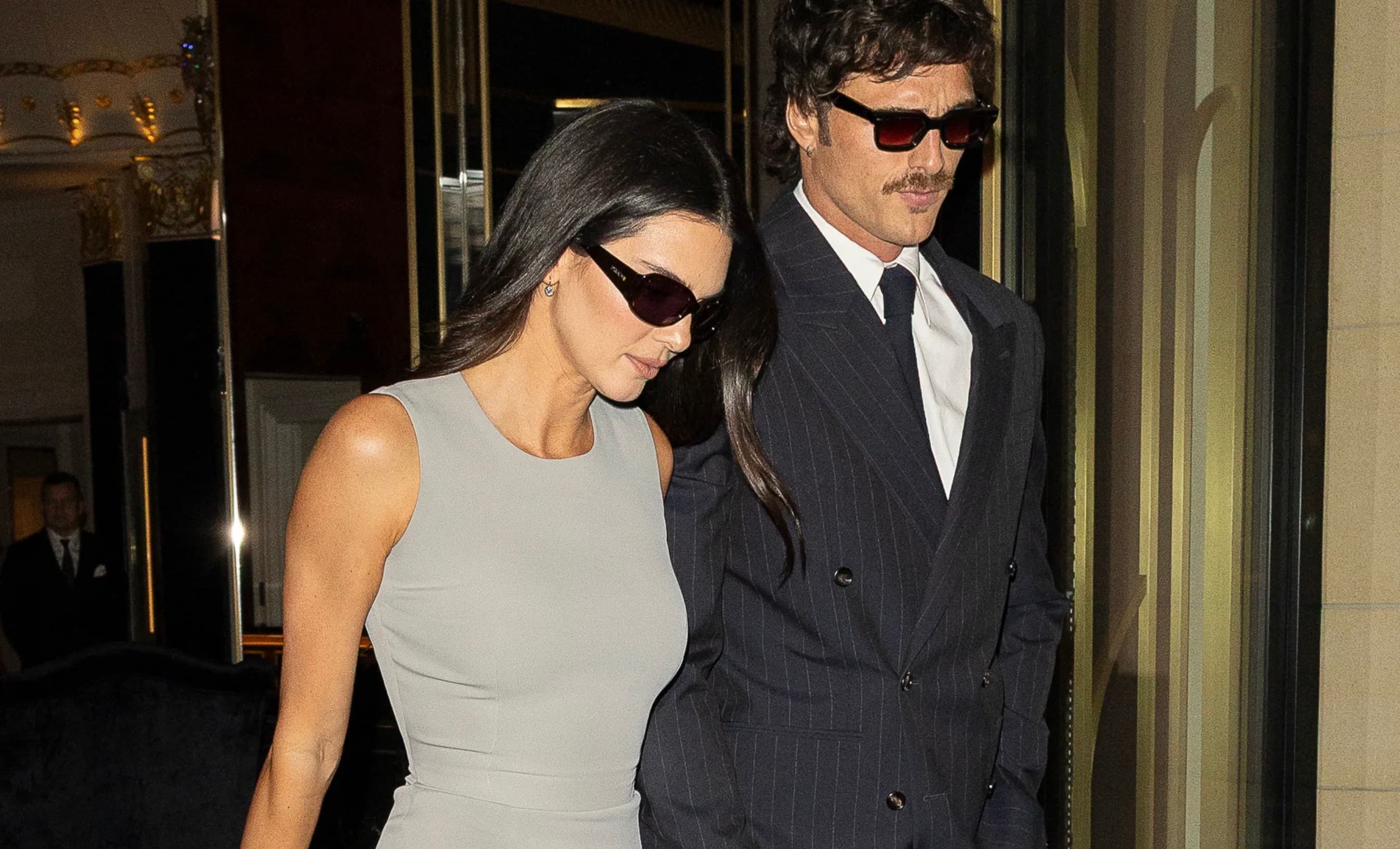 Kendall Jenner and Jacob Elordi walk together at night in London, both wearing sunglasses.